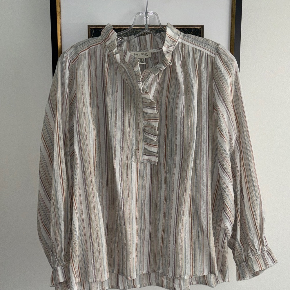 See U Soon blouse. Neutral color with multicolored striped pattern throughout.